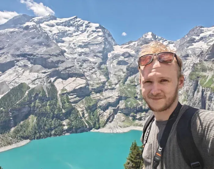 Adam Mitchell/Ishkur in front of the Oeschinensee, in Switzerland.
